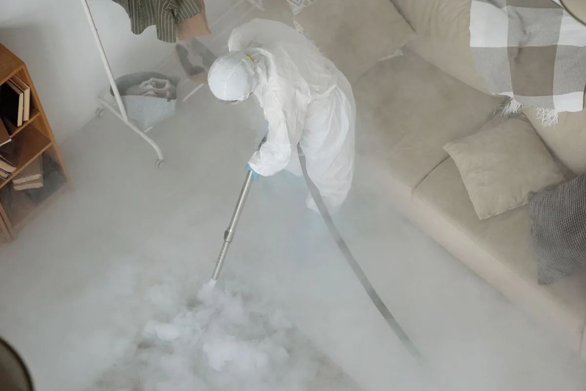 Biohazard cleanup technician in protective equipment, Kotzebue, AK